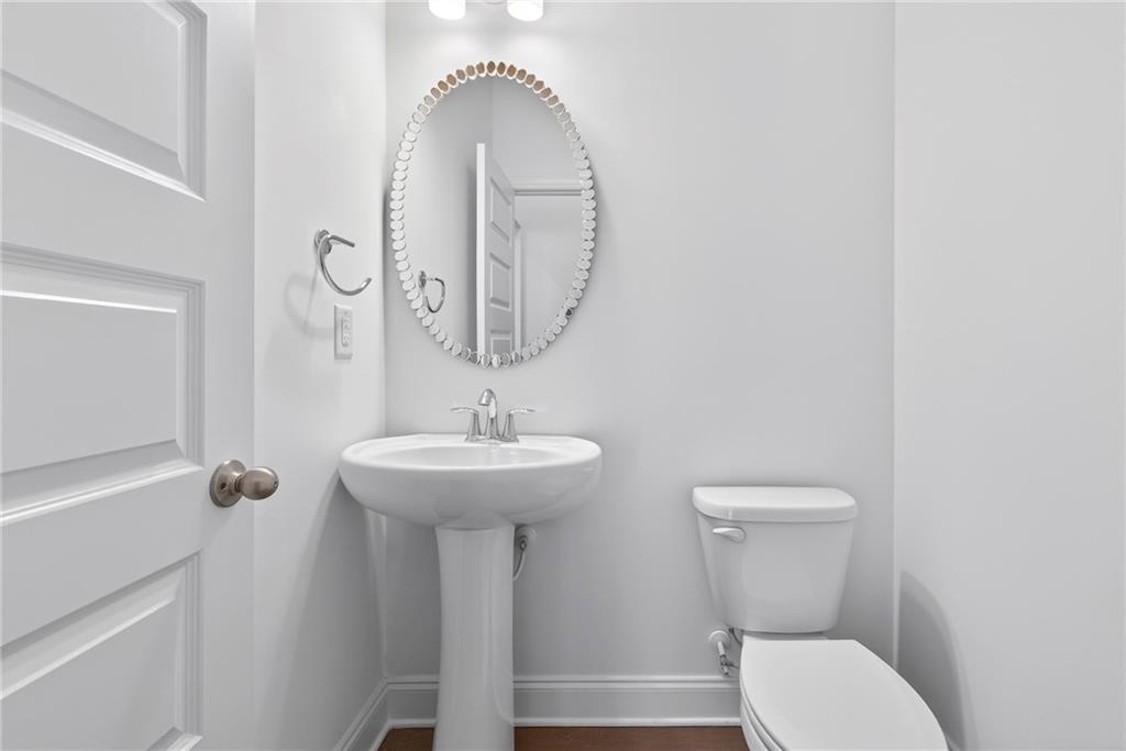 1752 Morningtide Lane Northeast Atlanta, GA 30324 - Photo 17 of 57 a bathroom with a toilet sink and mirror