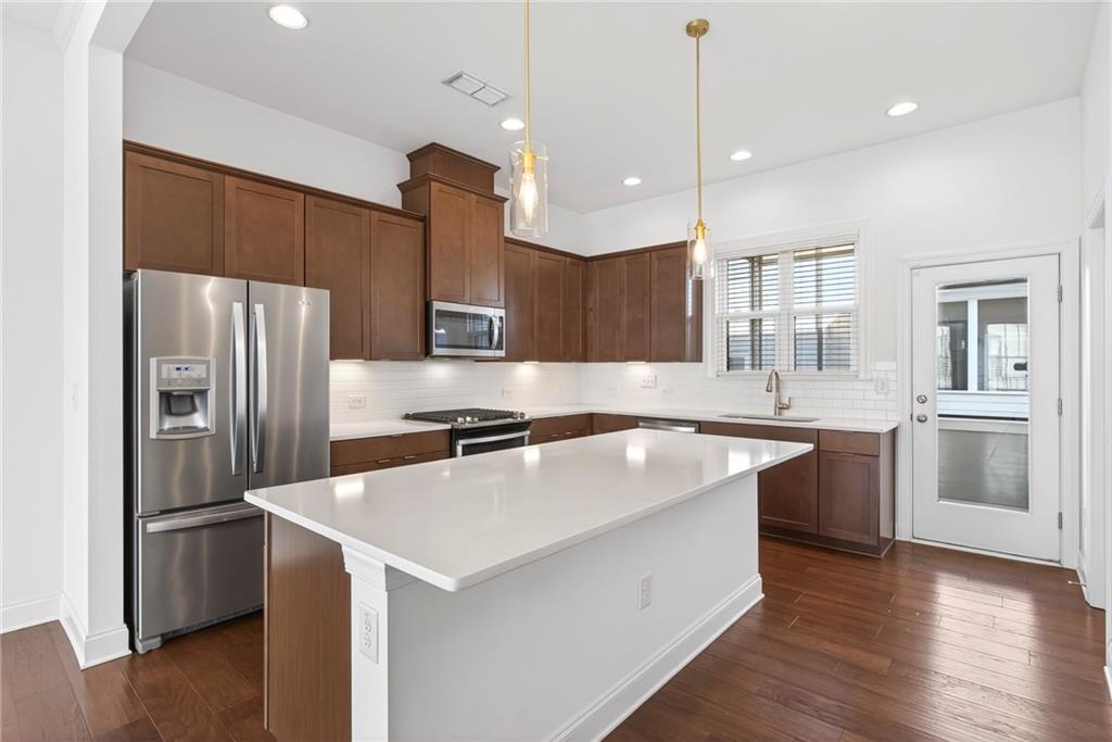 1752 Morningtide Lane Northeast Atlanta, GA 30324 - Photo 20 of 57 a kitchen with a refrigerator a sink and wooden floor