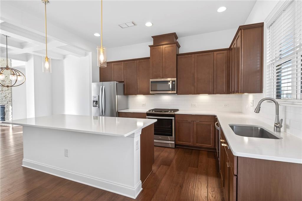 1752 Morningtide Lane Northeast Atlanta, GA 30324 - Photo 23 of 57 a kitchen with stainless steel appliances granite countertop a sink a stove and a wooden floors