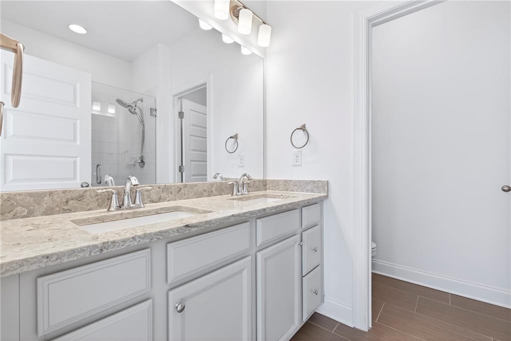 1752 Morningtide Lane Northeast Atlanta, GA 30324 - Photo 36 of 57 a bathroom with a granite countertop sink and a mirror