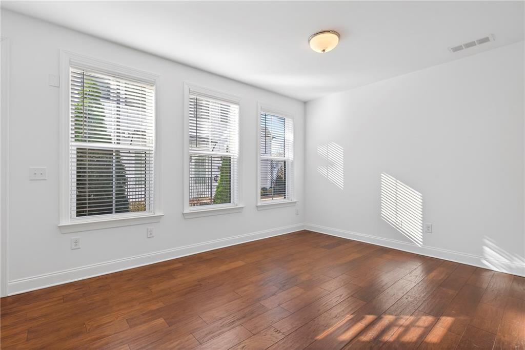 1752 Morningtide Lane Northeast Atlanta, GA 30324 - Photo 8 of 57 a view of an empty room with wooden floor and a window