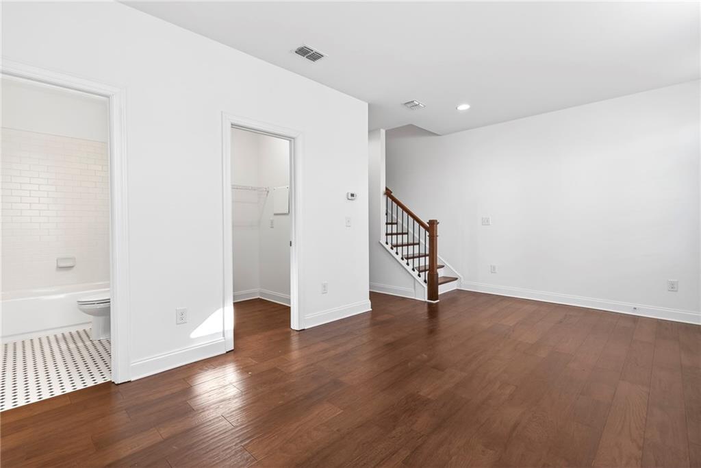 1752 Morningtide Lane Northeast Atlanta, GA 30324 - Photo 9 of 57 a view of an empty room with wooden floor and a window