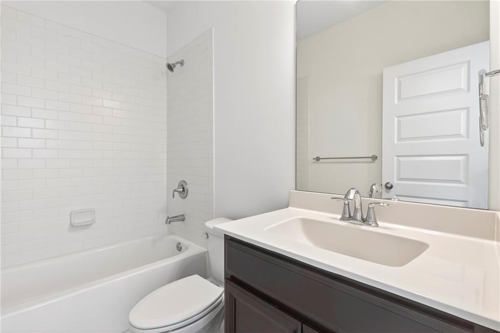1752 Morningtide Lane Northeast Atlanta, GA 30324 - Photo 10 of 57 a bathroom with a sink a toilet and bathtub
