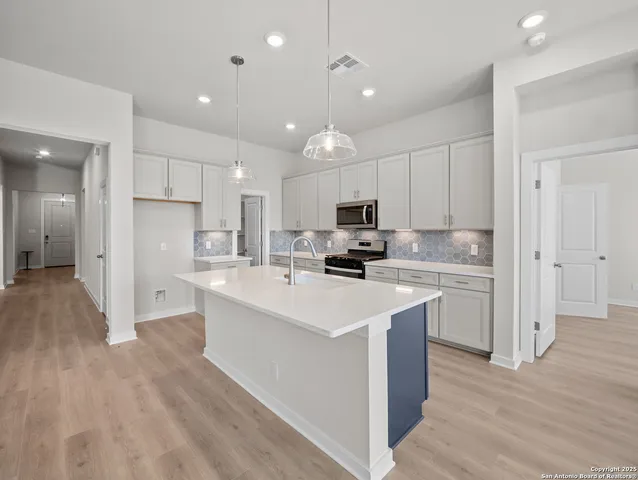 a kitchen with refrigerator a sink and cabinets