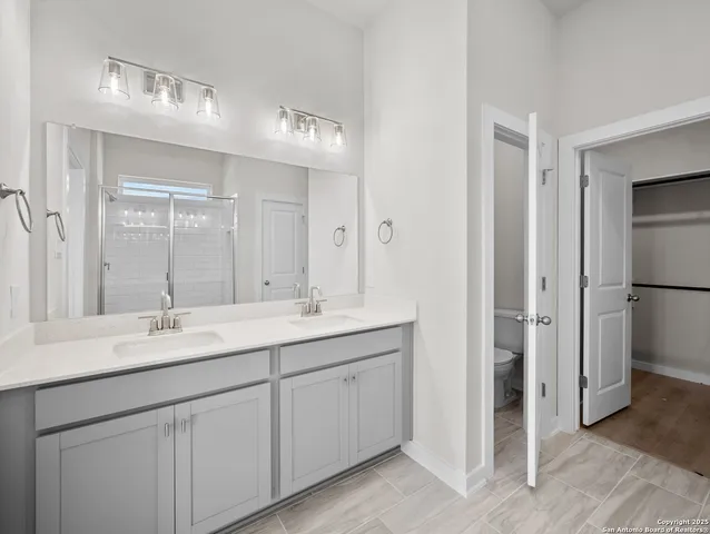 a bathroom with a double vanity sink mirror and double