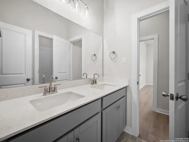 a bathroom with a sink double vanity and a mirror