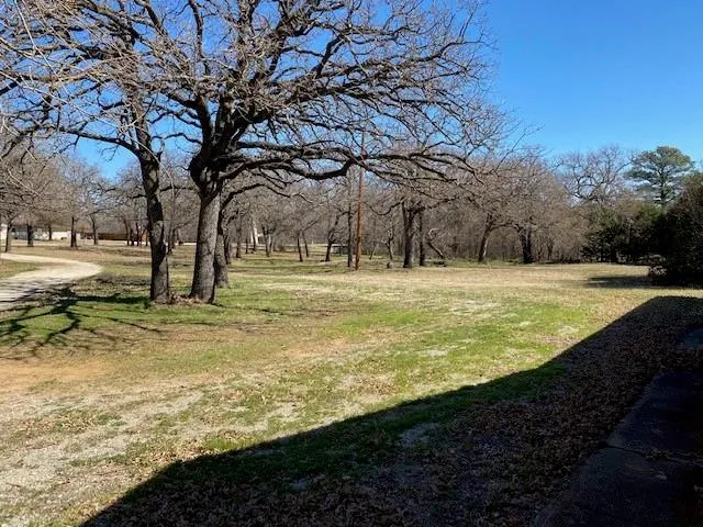 a view of outdoor space with trees all around