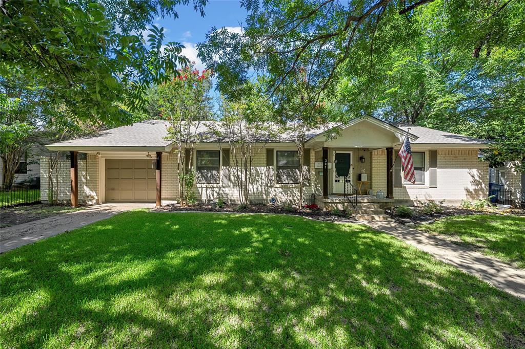301 North 40th Street Waco, TX 76710 - Photo 2 of 26 Single-story residence featuring a brick exterior with a front porch, an attached garage, and mature landscaping