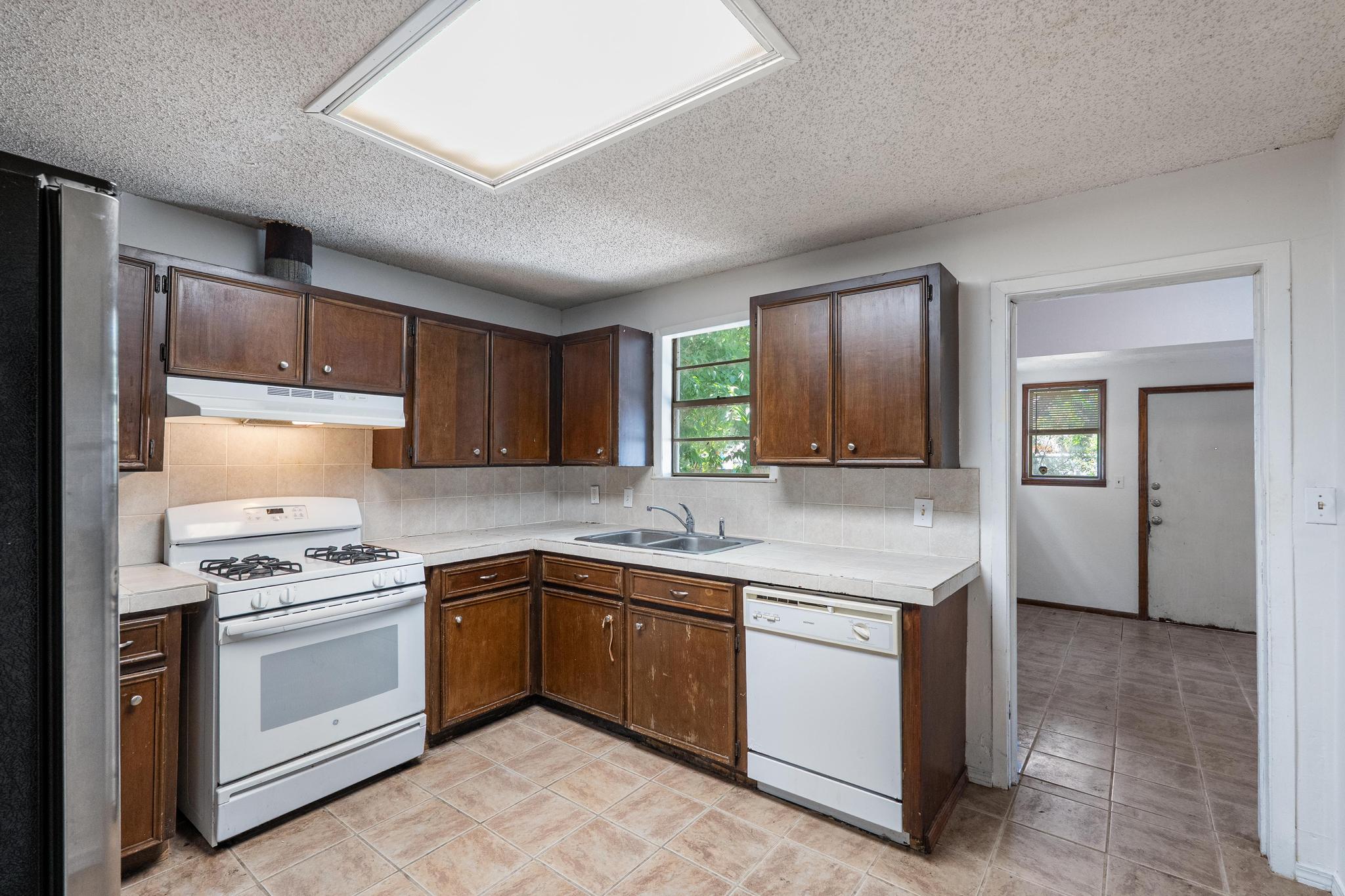 4616 East Cesar Chavez Street Austin, TX 78702 - Photo 14 of 22 a kitchen with a stove sink and cabinets