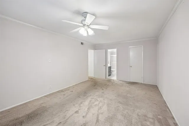 a view of an empty room with a fan