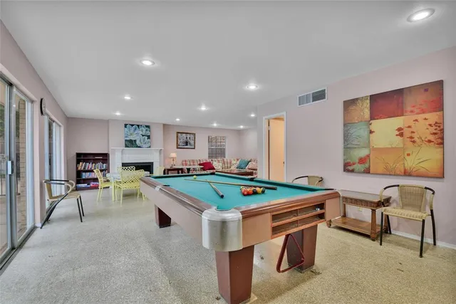 a room with furniture and pool table