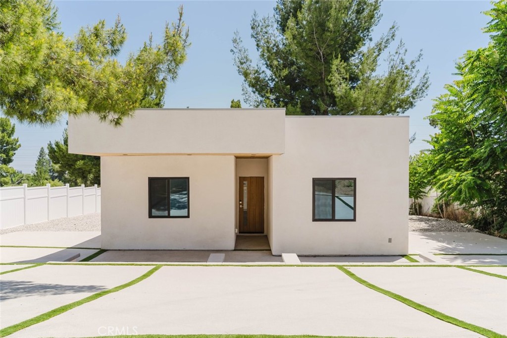 17846 Rinaldi Street Granada Hills, CA 91344 - Photo 2 of 34 a house with trees in the background