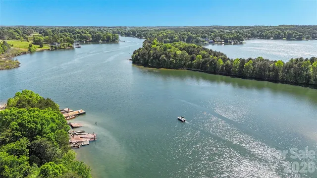 a view of a lake with lawn chairs