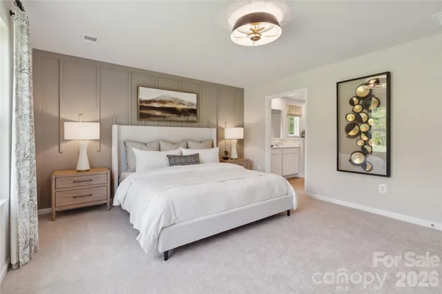 a bedroom with a bed and a painting on the wall