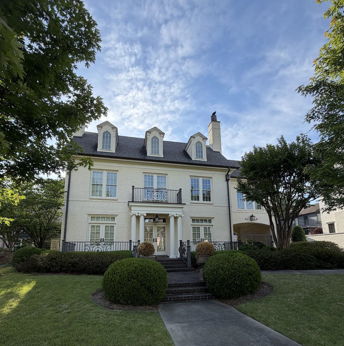 1692 Cordova Road Germantown, TN 38138 - Photo 1 of 1 Stately brick exterior with a painted finish, featuring a prominent portico with white columns and an ornate wrought-iron balcony