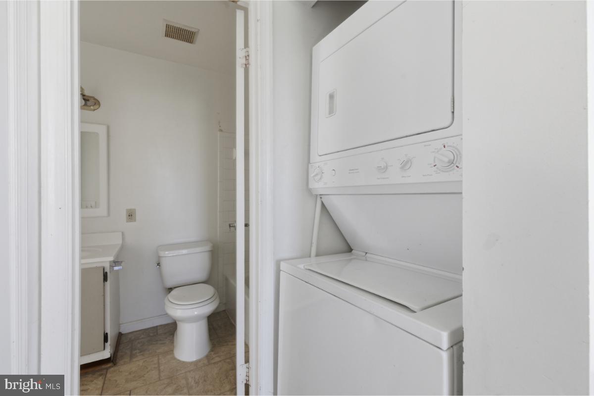 1403 Key Parkway, Unit 201 Frederick, MD 21702 - Photo 11 of 20 a white toilet sitting next to a bathroom sink