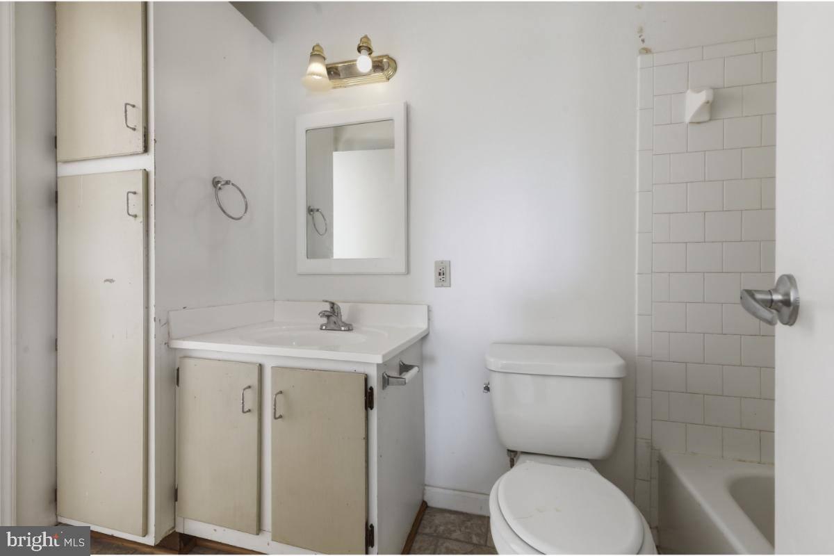1403 Key Parkway, Unit 201 Frederick, MD 21702 - Photo 12 of 20 a bathroom with a toilet a sink and mirror