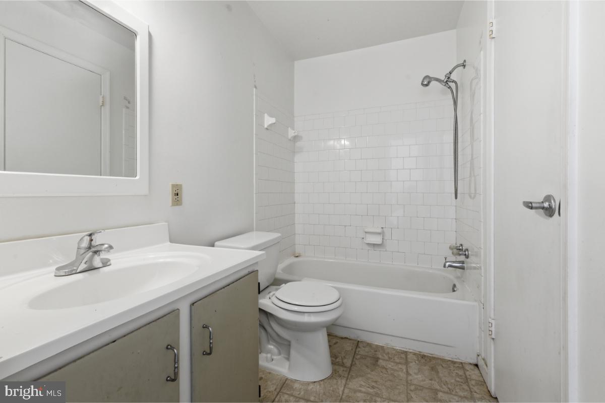 1403 Key Parkway, Unit 201 Frederick, MD 21702 - Photo 13 of 20 a bathroom with a sink toilet and shower
