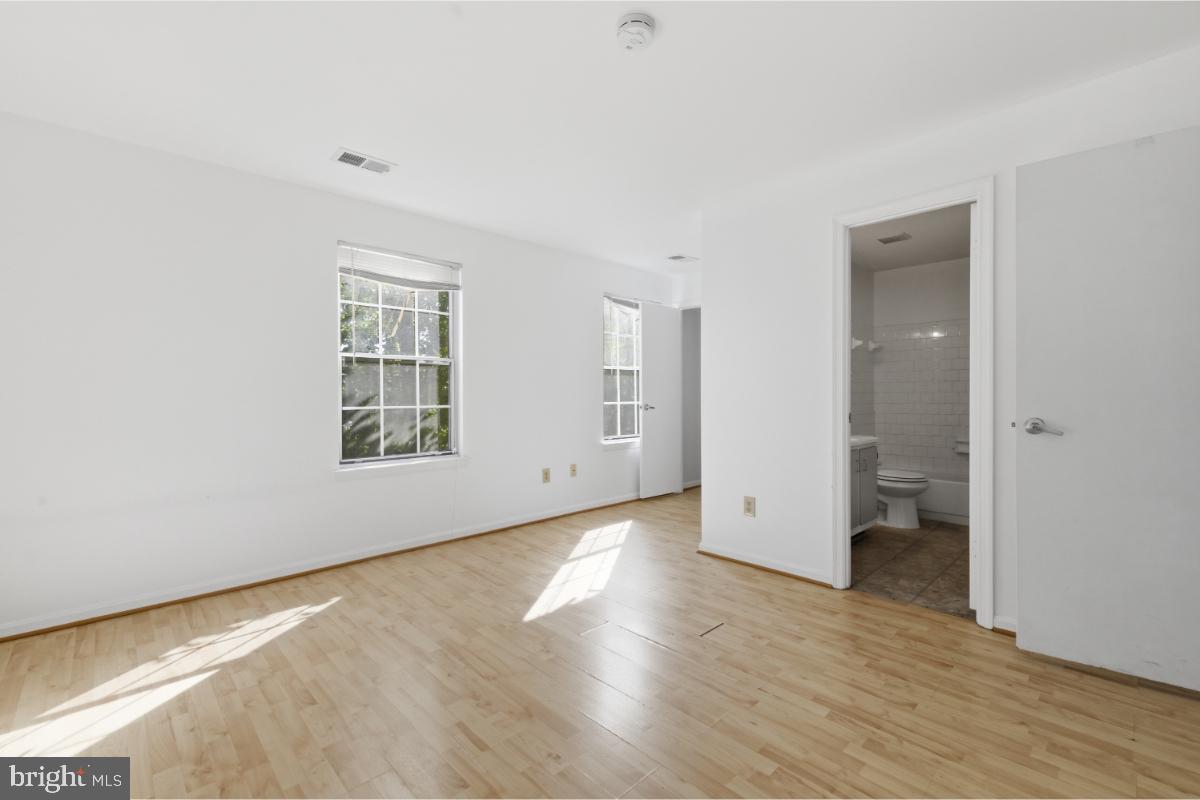 1403 Key Parkway, Unit 201 Frederick, MD 21702 - Photo 16 of 20 an empty room with wooden floor and a window