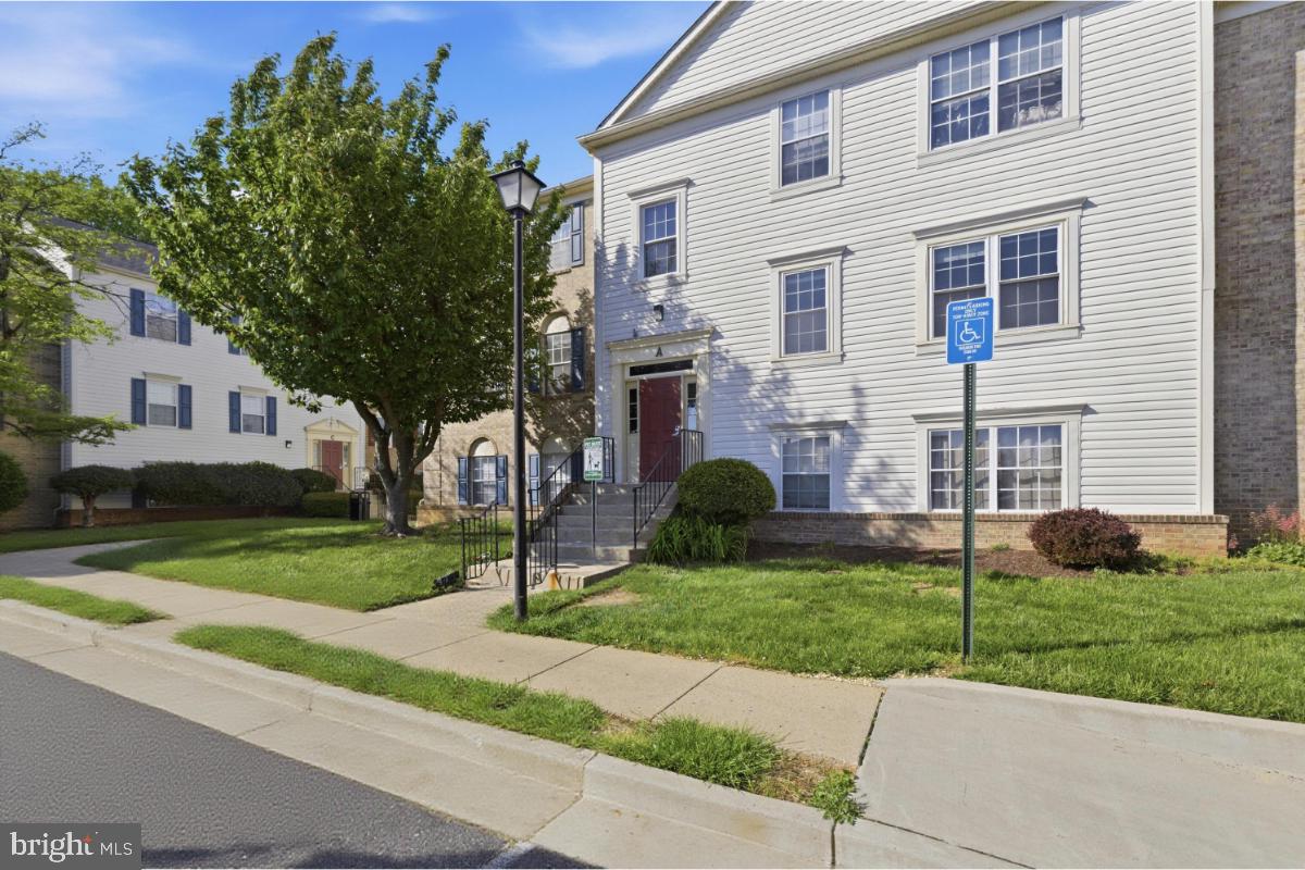 1403 Key Parkway, Unit 201 Frederick, MD 21702 - Photo 20 of 20 a view of a house with a yard and a garden