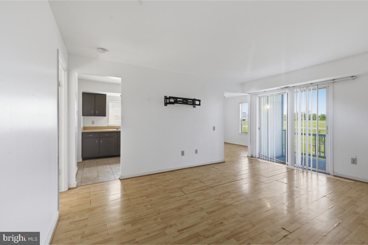 1403 Key Parkway, Unit 201 Frederick, MD 21702 - Photo 4 of 20 an empty room with wooden floor and windows