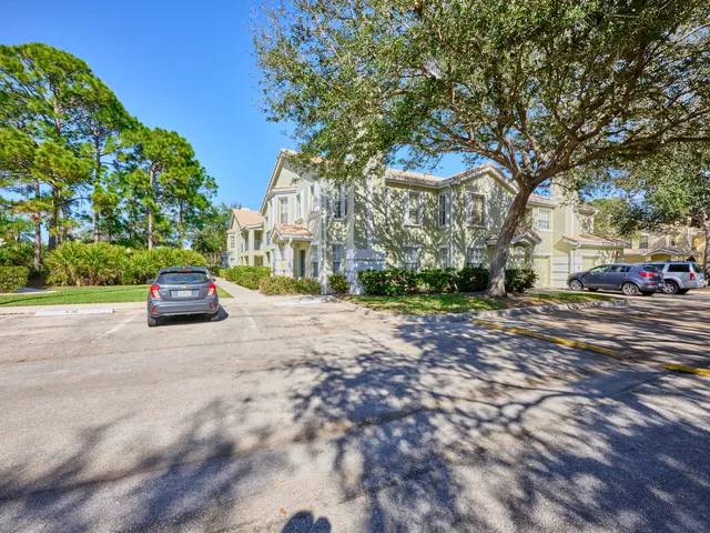 a kitchen with stainless steel appliances granite countertop a stove a sink and white cabinets