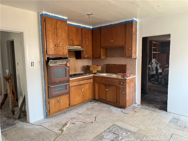 a kitchen with stainless steel appliances granite countertop a refrigerator stove and sink
