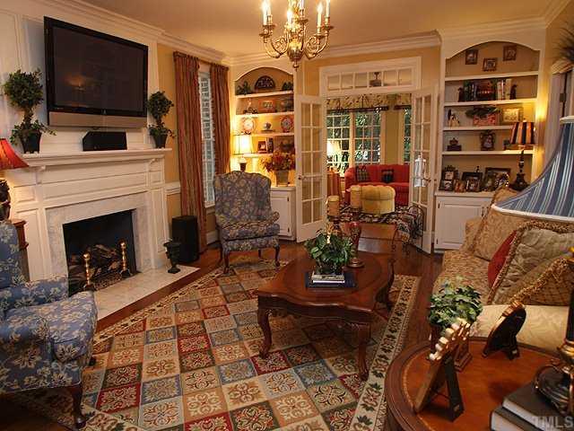 3201 Brantford Place Raleigh, NC 27607 - Photo 2 of 12 a living room with furniture a flat screen tv and a fireplace