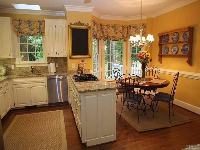 3201 Brantford Place Raleigh, NC 27607 - Photo 5 of 12 a kitchen that has a table and chairs in it