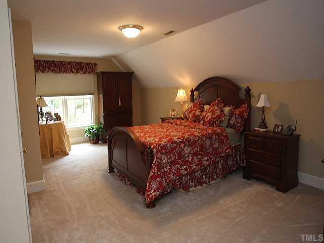 3201 Brantford Place Raleigh, NC 27607 - Photo 10 of 12 a bedroom with a bed and a mirror