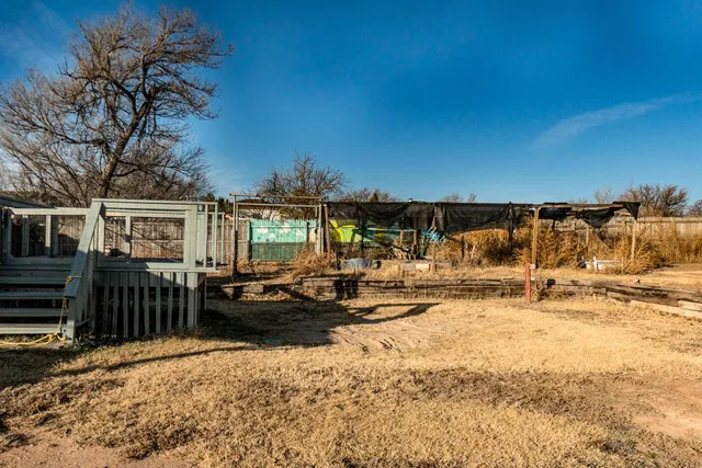 a view of a ocean with a barbeque and wooden stairs