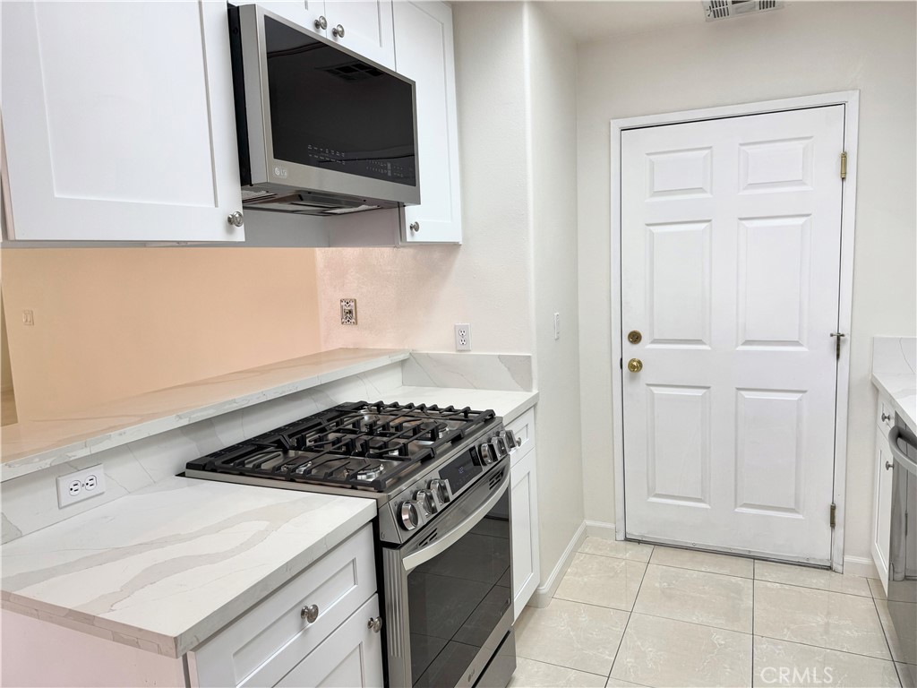 18319 Hart Street, Unit 3 Reseda, CA 91335 - Photo 8 of 18 a kitchen with a stove and a microwave