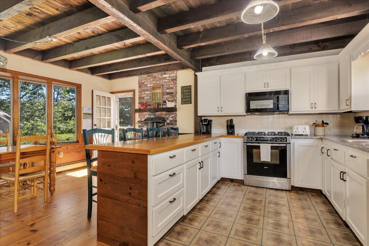 60 Pleasant Point Road Wellfleet, MA 02667 - Photo 12 of 58 a kitchen with stainless steel appliances granite countertop a stove a sink and a refrigerator