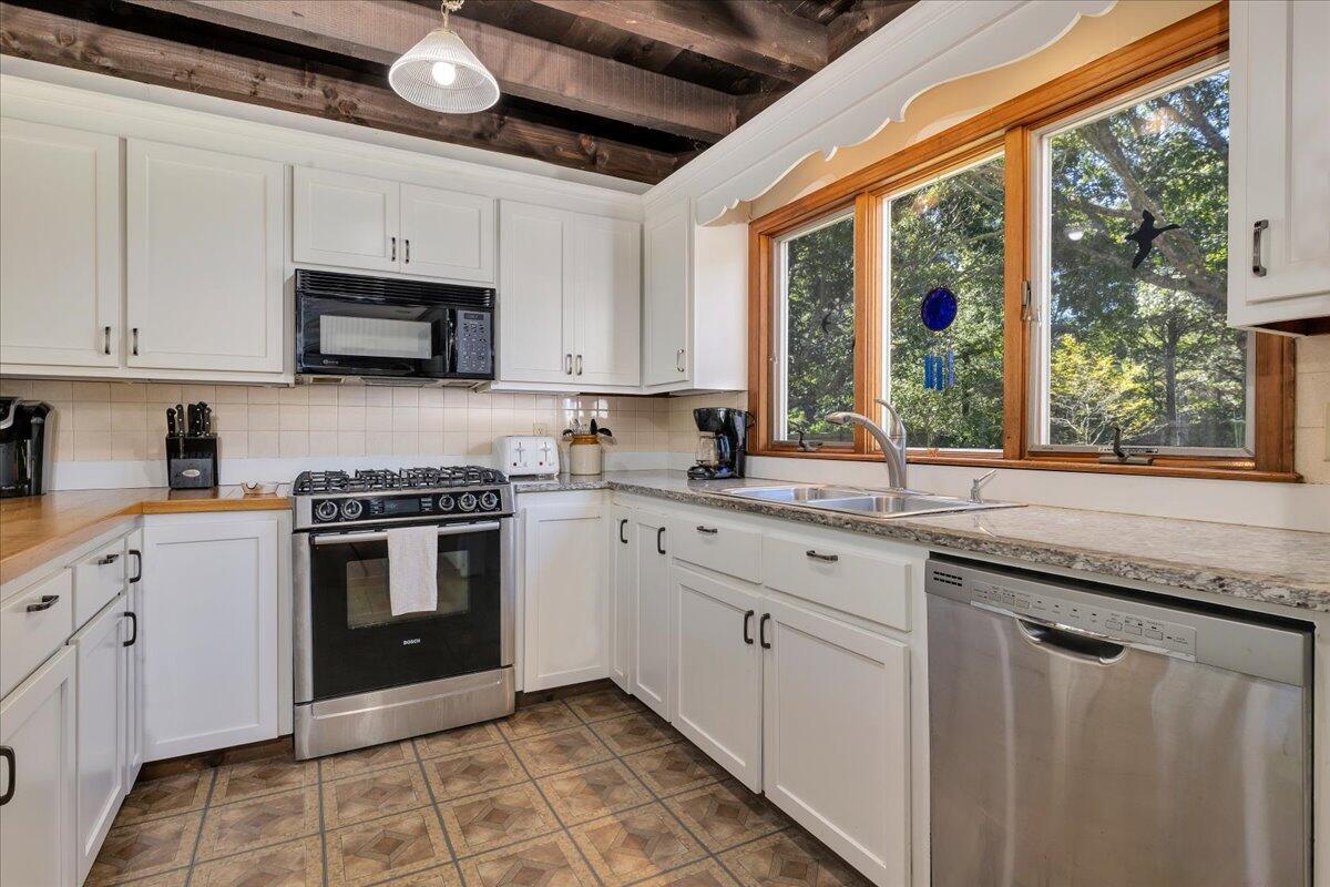 60 Pleasant Point Road Wellfleet, MA 02667 - Photo 13 of 58 a kitchen with stainless steel appliances granite countertop a stove sink and cabinets