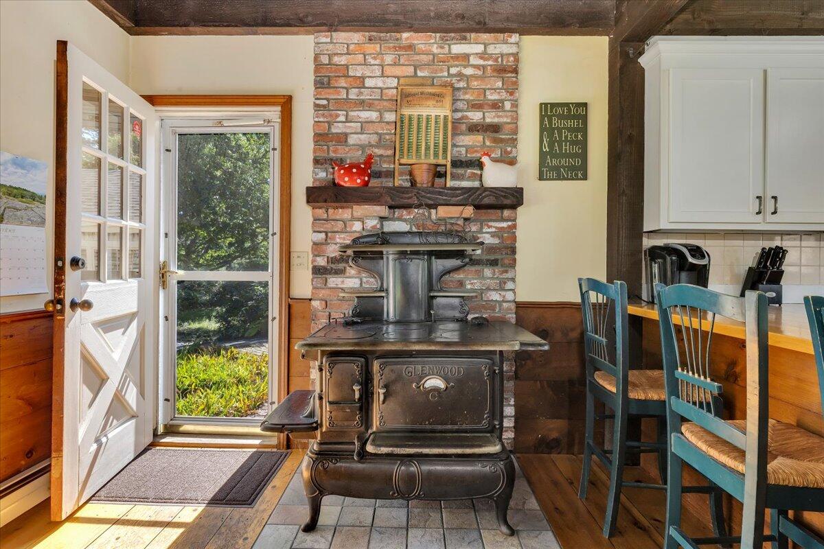60 Pleasant Point Road Wellfleet, MA 02667 - Photo 16 of 58 a view of a kitchen with furniture and a fireplace