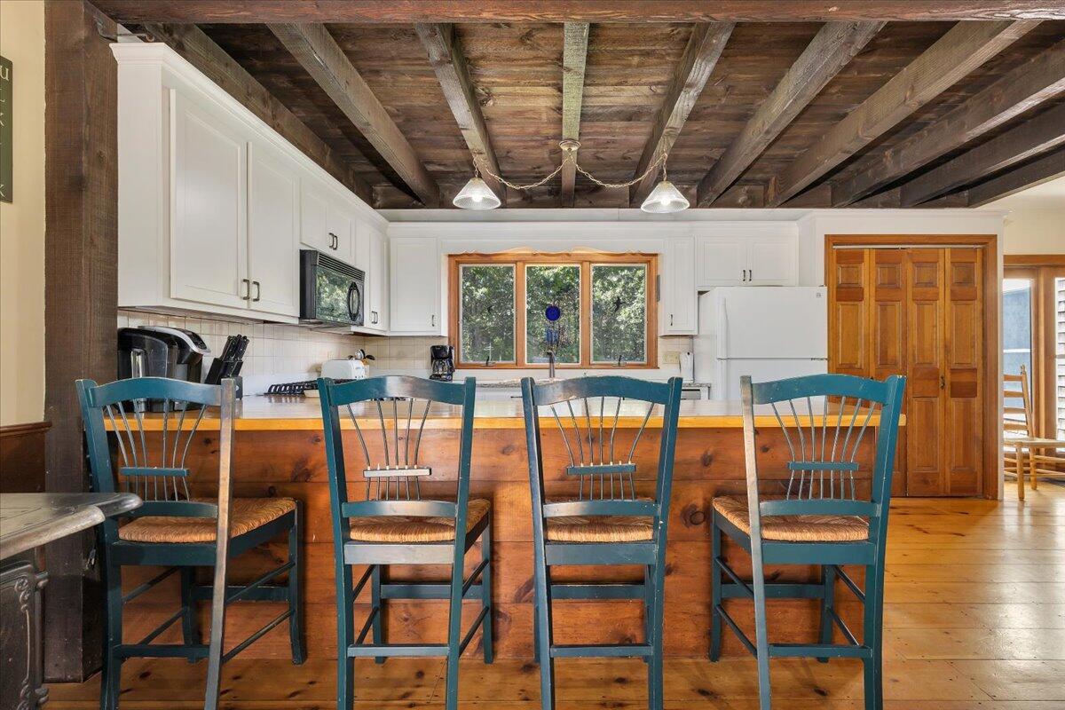 60 Pleasant Point Road Wellfleet, MA 02667 - Photo 17 of 58 a view of a dining room with furniture window and wooden floor
