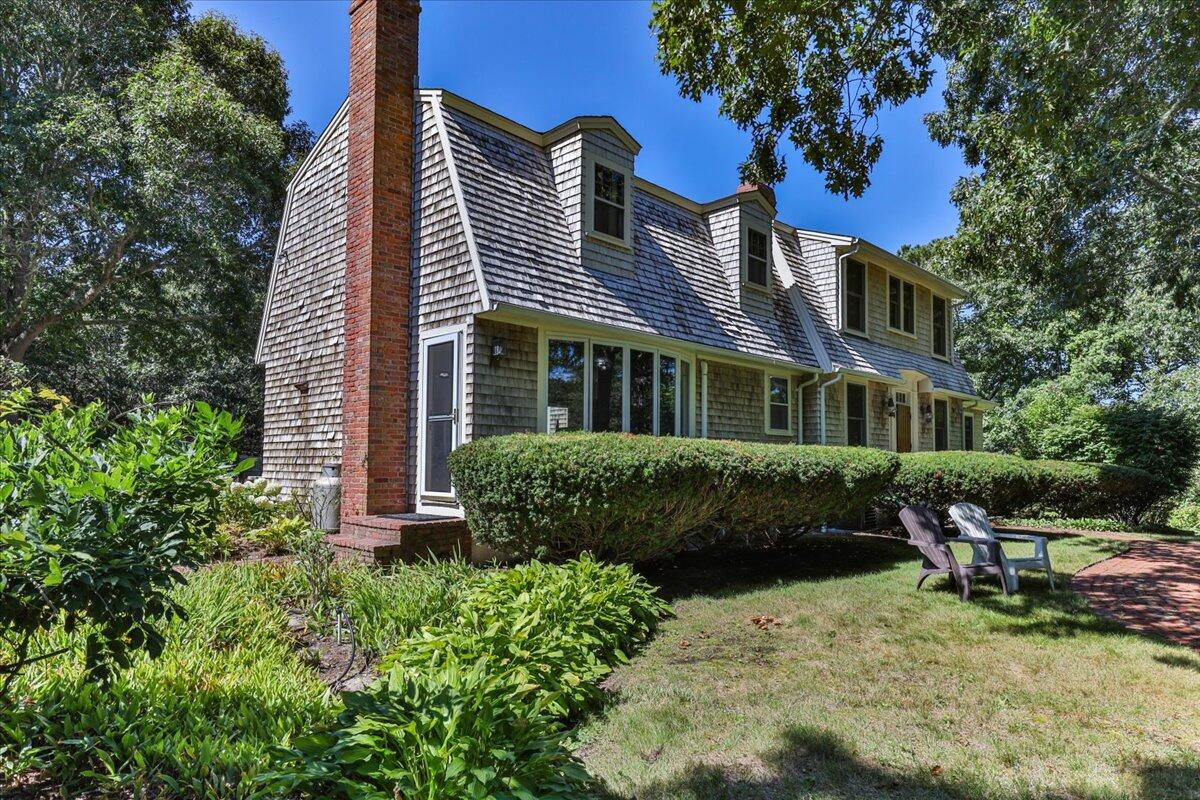 60 Pleasant Point Road Wellfleet, MA 02667 - Photo 3 of 58 a front view of a house with a yard