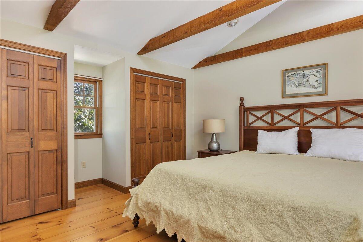 60 Pleasant Point Road Wellfleet, MA 02667 - Photo 31 of 58 a bedroom with a bed and painting on the wall