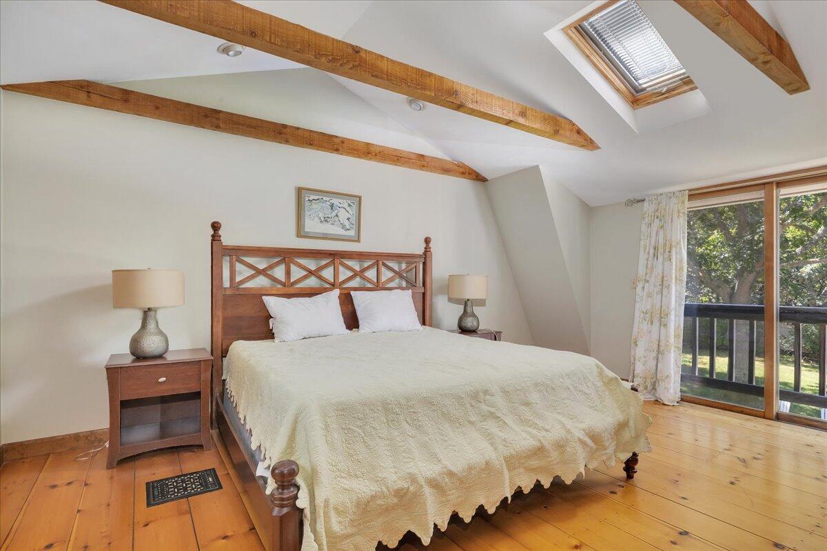 60 Pleasant Point Road Wellfleet, MA 02667 - Photo 32 of 58 a bedroom with a bed and wooden floor