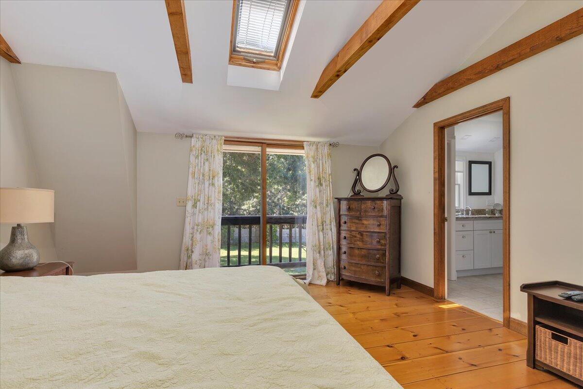 60 Pleasant Point Road Wellfleet, MA 02667 - Photo 33 of 58 a bedroom with a bed a mirror on dresser and a table