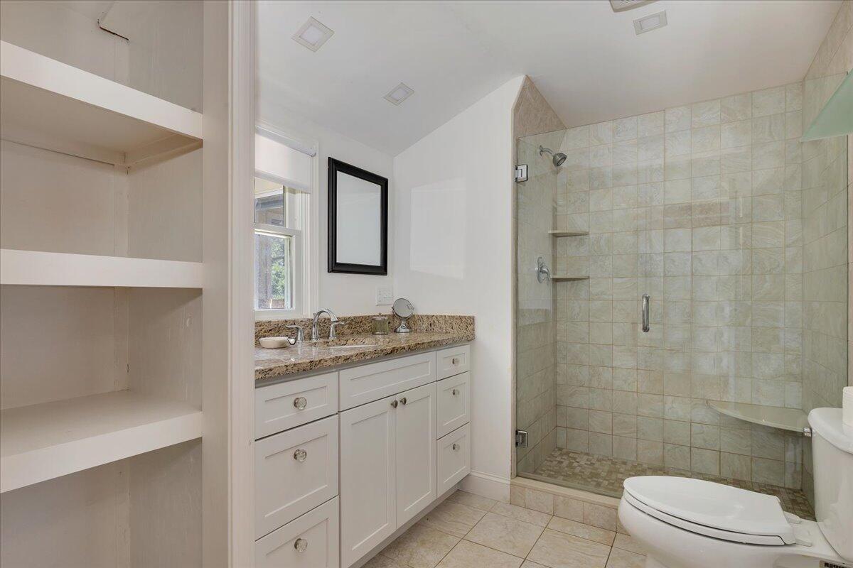 60 Pleasant Point Road Wellfleet, MA 02667 - Photo 34 of 58 a bathroom with a granite countertop sink toilet a mirror and shower