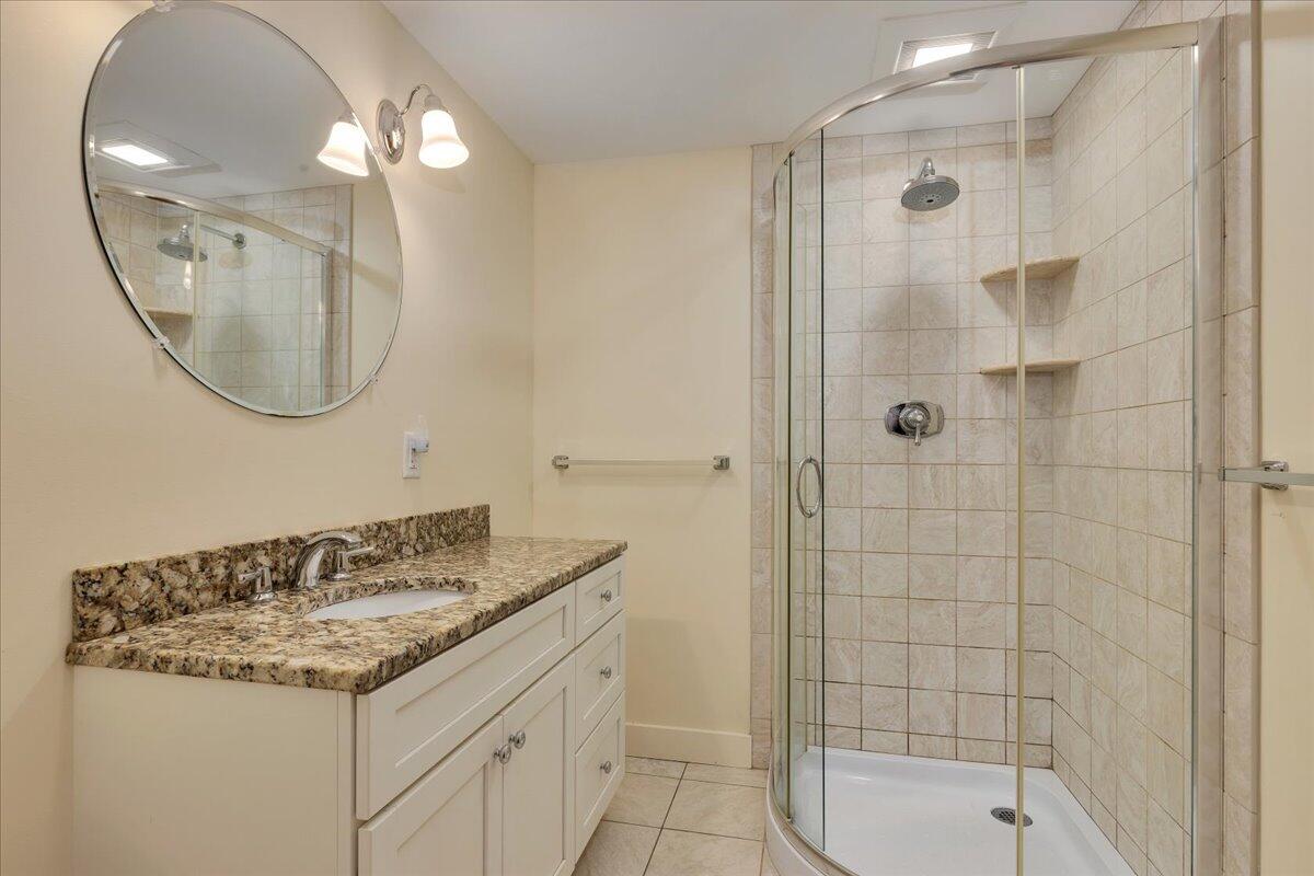 60 Pleasant Point Road Wellfleet, MA 02667 - Photo 41 of 58 a bathroom with a granite countertop sink a mirror and a shower