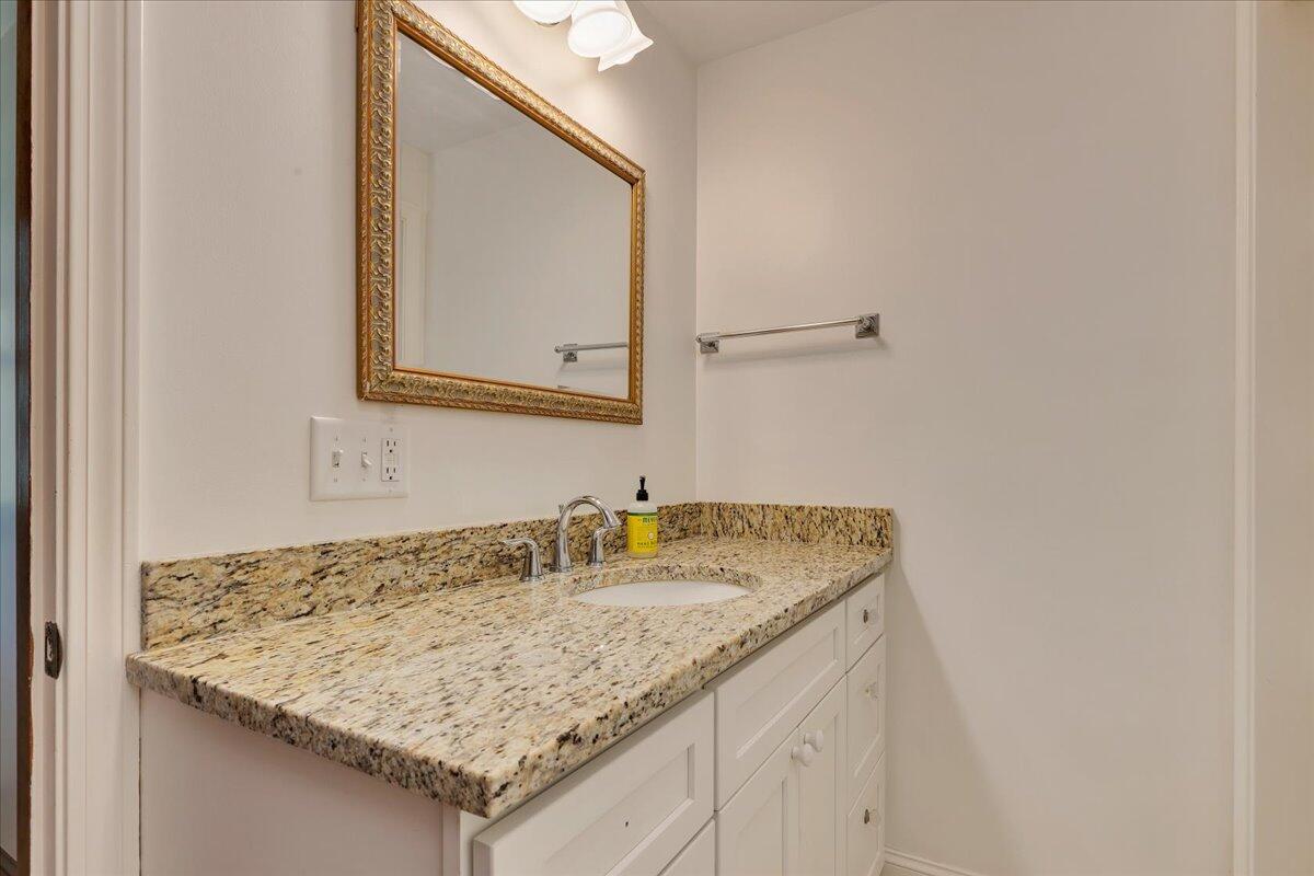 60 Pleasant Point Road Wellfleet, MA 02667 - Photo 45 of 58 a bathroom with a granite countertop sink and a mirror