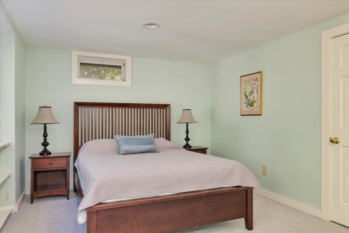 60 Pleasant Point Road Wellfleet, MA 02667 - Photo 48 of 58 a bedroom with a bed and wall painting