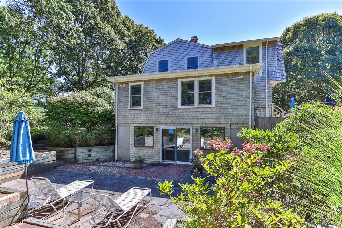 60 Pleasant Point Road Wellfleet, MA 02667 - Photo 50 of 58 a front view of a house with a yard and garage