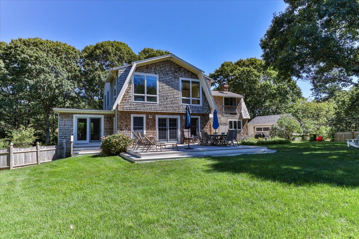 60 Pleasant Point Road Wellfleet, MA 02667 - Photo 5 of 58 a front view of a house with garden and trees