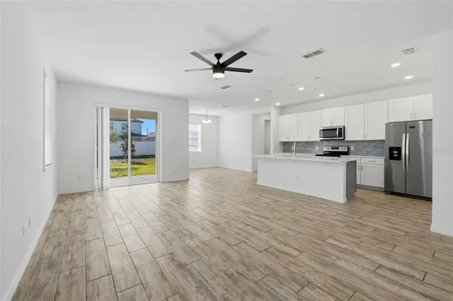 a view of a kitchen with a sink and a refrigerator