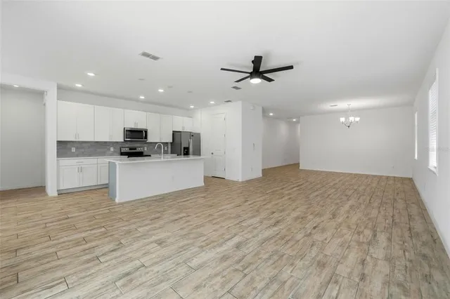 a view of a kitchen with a sink and a refrigerator