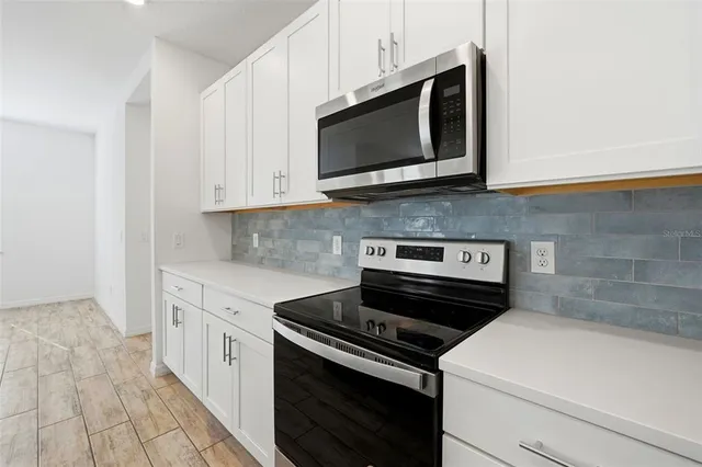 a kitchen with a stove and a microwave