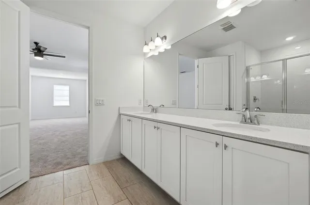 a bathroom with a double vanity sink and a mirror